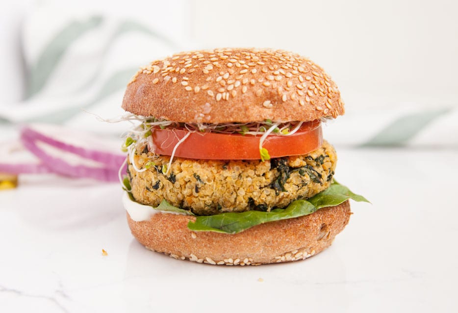 Garlic and kale burger with sprouts, tomato, and lettuce.