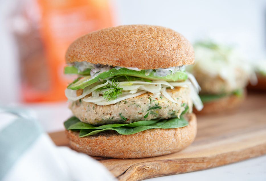 White bean burger with avocado and spinach.