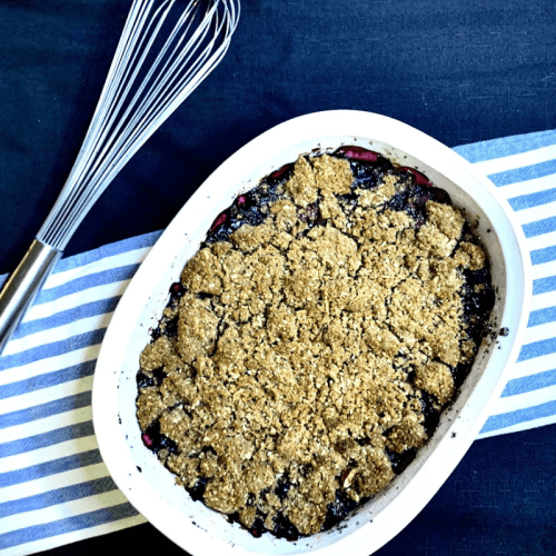A dish full of Jael & Janya's easy Blueberry Raspberry Sprouted Breadcrumb Betty dessert